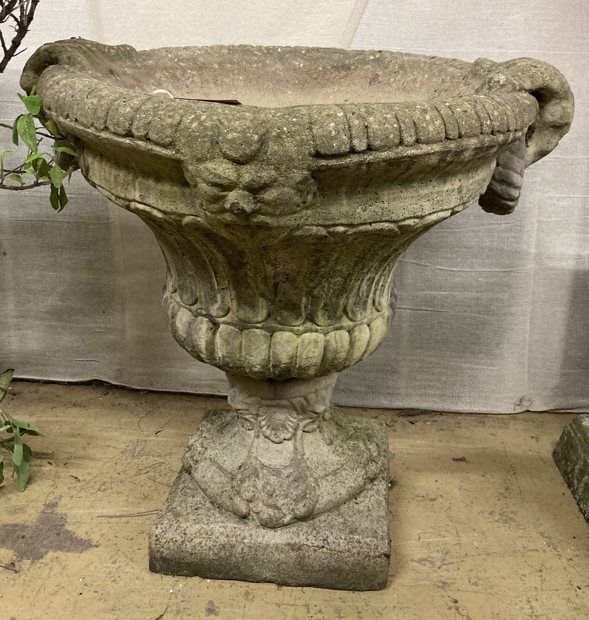 A reconstituted stone campana garden urn, width 66cm, depth 60cm, height 64cm